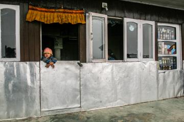 Enfant accoudé à la fenêtre de sa maison dans un village du Parc National de Singalila | © Marion Brun Enfant accoudé à la fenêtre de sa maison dans un village du Parc National de Singalila | © Marion Brun